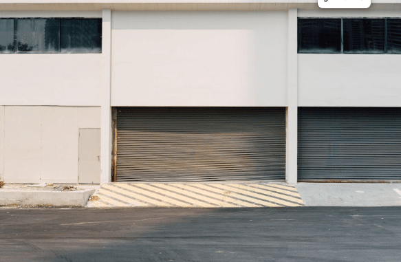 A brown metal garage door with horizontal panels on a residential building.